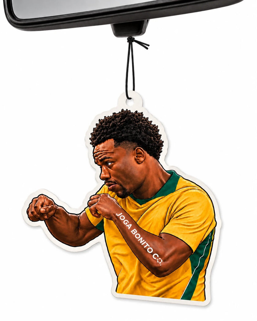 Joga Bonito Co. football player car air freshener hanging from a rear-view mirror